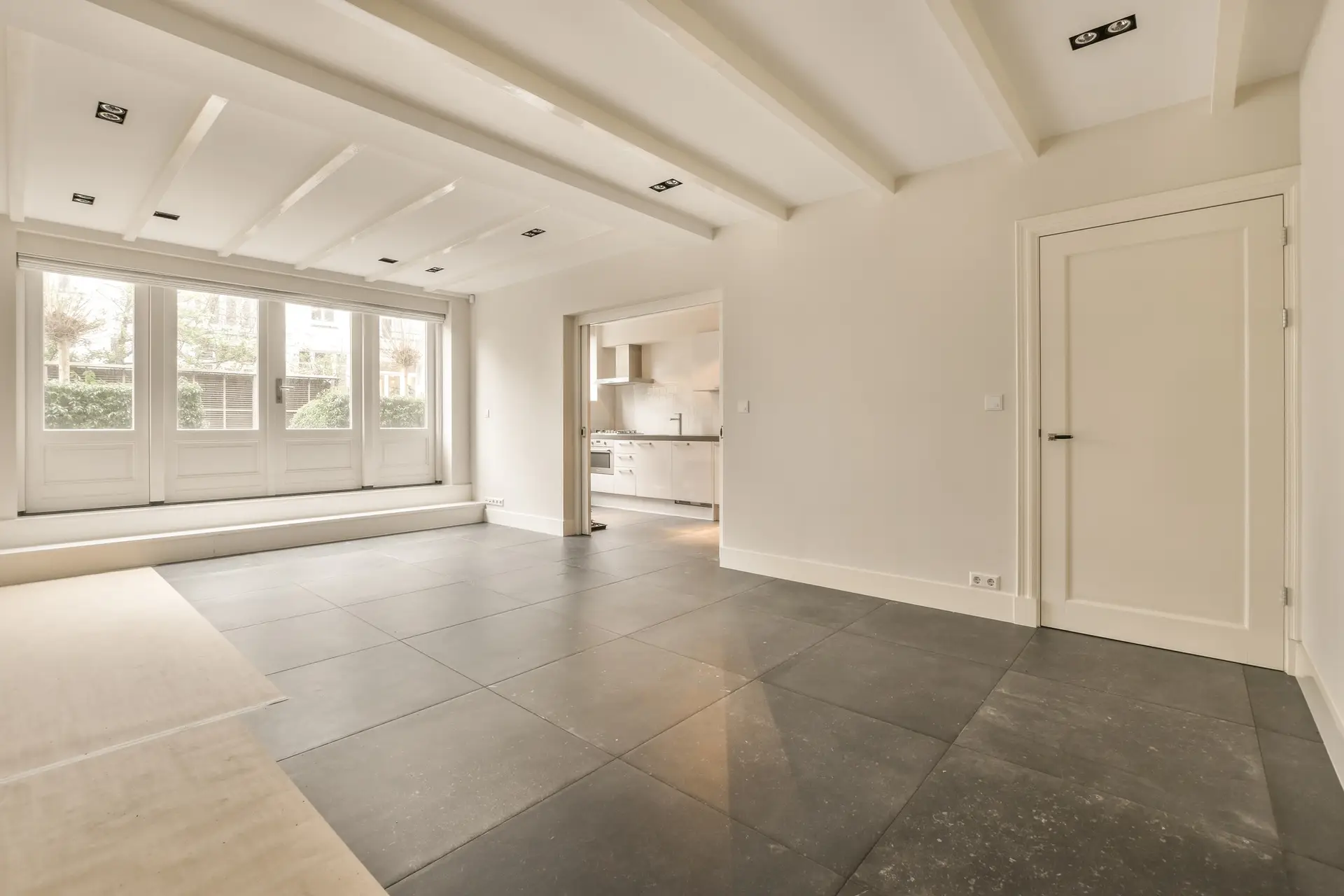 Empty room with white walls and tiled floor